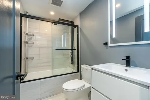 a bathroom with a shower a toilet and sink