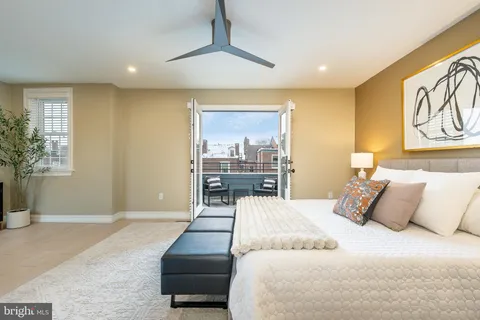 a bedroom with a large bed and a couch