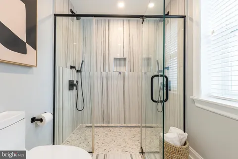 a bathroom with a shower and a sink
