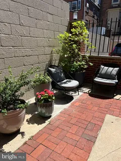a view of a backyard with chair and the potted plants