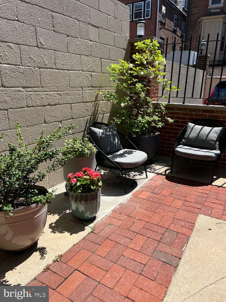 908 Spruce Street, Unit 10 Philadelphia, PA 19107 - Photo 31 of 41 a view of a backyard with chair and the potted plants