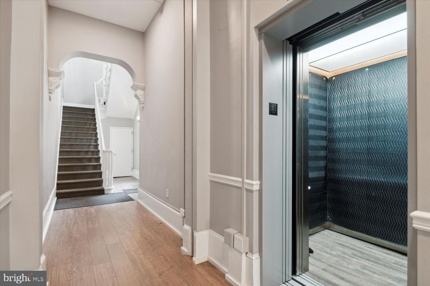 908 Spruce Street, Unit 10 Philadelphia, PA 19107 - Photo 33 of 41 a view of a hallway with wooden floor and staircase