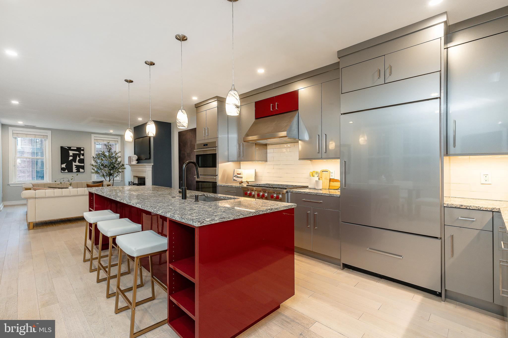 908 Spruce Street, Unit 10 Philadelphia, PA 19107 - Photo 5 of 41 a kitchen with stainless steel appliances granite countertop a refrigerator a stove and a sink