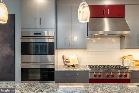 a kitchen with granite countertop a stove and a microwave