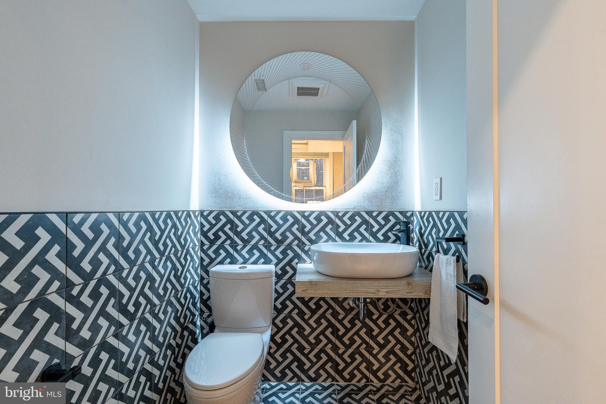 908 Spruce Street, Unit 10 Philadelphia, PA 19107 - Photo 7 of 41 a bathroom with a toilet a sink and a mirror