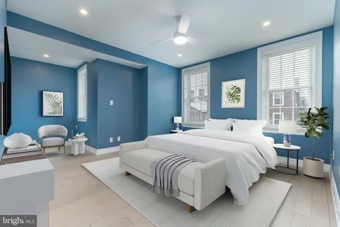 a bedroom with a bed and ceiling fan
