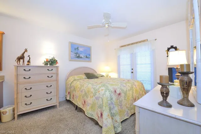 a bedroom with a bed and ceiling fan