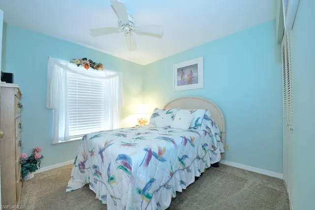 a bedroom with bed and a chandelier