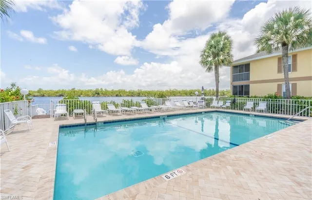 a view of a swimming pool and an outdoor seating
