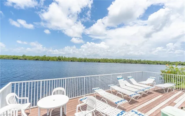 a view of balcony with wooden floor and lake view