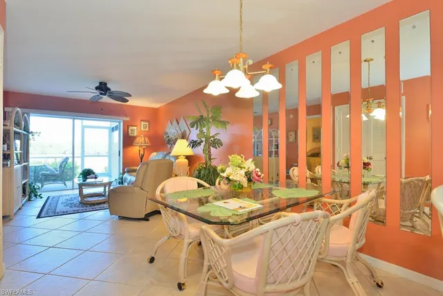 a dining room with furniture a chandelier and a rug