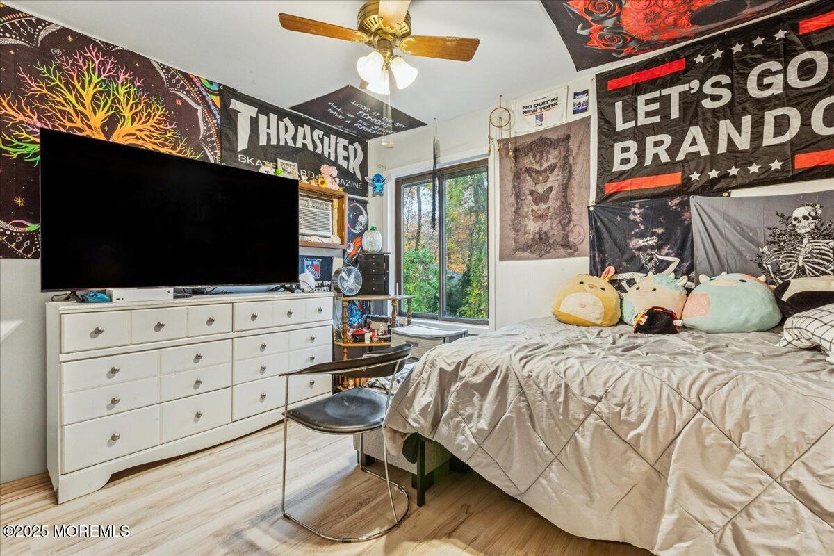 93 Arrowood Road, Unit G Manalapan, NJ 07726 - Photo 14 of 16 a bedroom with a bed and flat screen tv