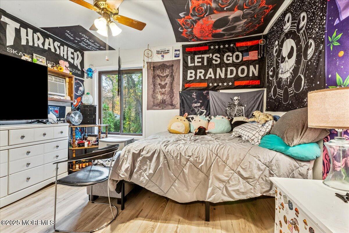 93 Arrowood Road, Unit G Manalapan, NJ 07726 - Photo 15 of 16 a bedroom with bed and a flat tv screen on dresser