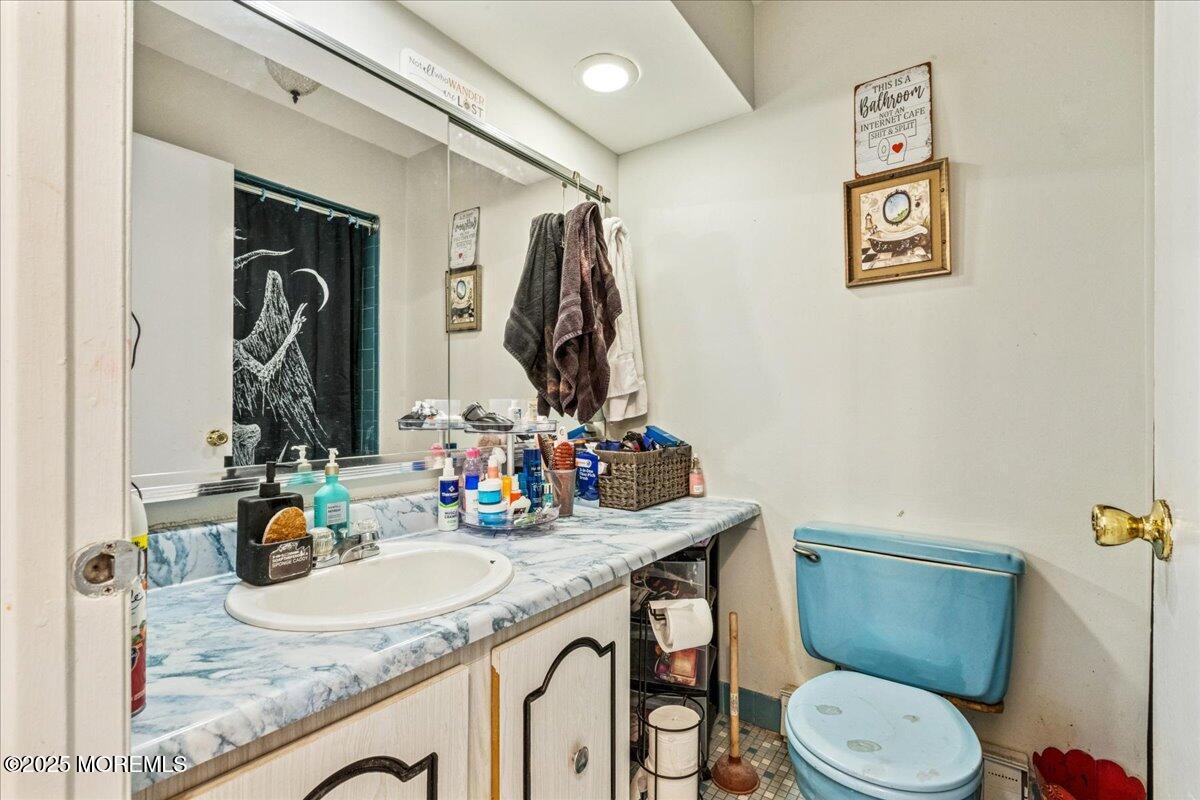 93 Arrowood Road, Unit G Manalapan, NJ 07726 - Photo 16 of 16 a bathroom with a granite countertop sink mirror vanity and toilet