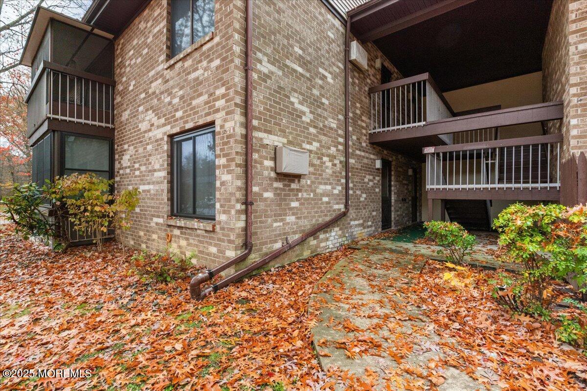 93 Arrowood Road, Unit G Manalapan, NJ 07726 - Photo 2 of 16 a front view of a house with garden