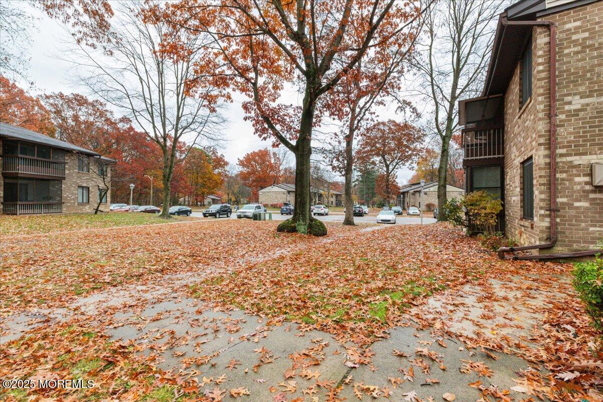 93 Arrowood Road, Unit G Manalapan, NJ 07726 - Photo 3 of 16 a street view covered with snow