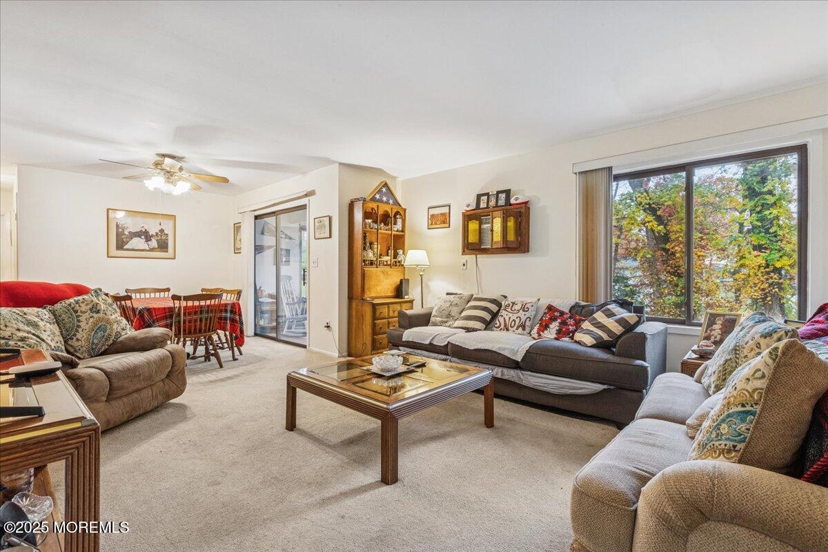 93 Arrowood Road, Unit G Manalapan, NJ 07726 - Photo 8 of 16 a living room with furniture and a large window