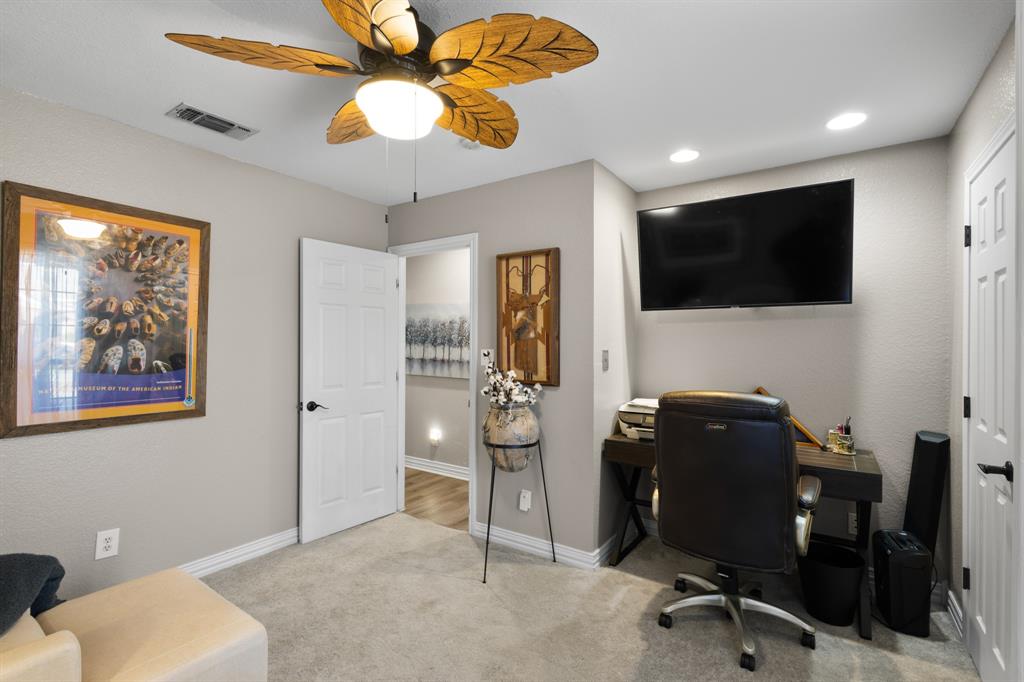 1701 Oakmeadow Drive Decatur, TX 76234 - Photo 22 of 39 a view of a workspace with furniture and a flat screen tv