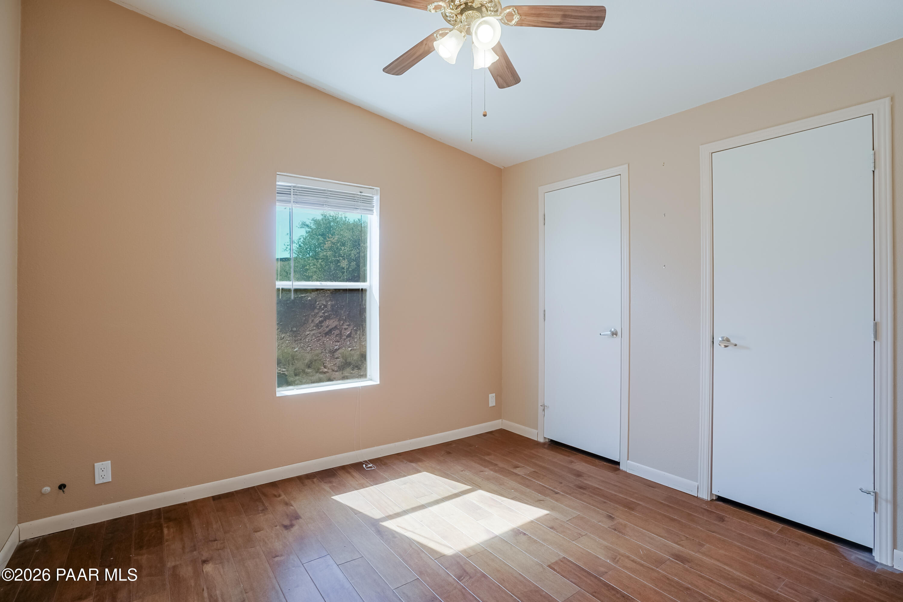 11800 Henderson Road Dewey-Humboldt, AZ 86327 - Photo 21 of 54 a view of an empty room with wooden floor and a window