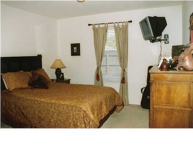 185 Beacon Way Miramar Beach, FL 32550 - Photo 9 of 14 a bedroom with a bed a flat screen tv and dresser