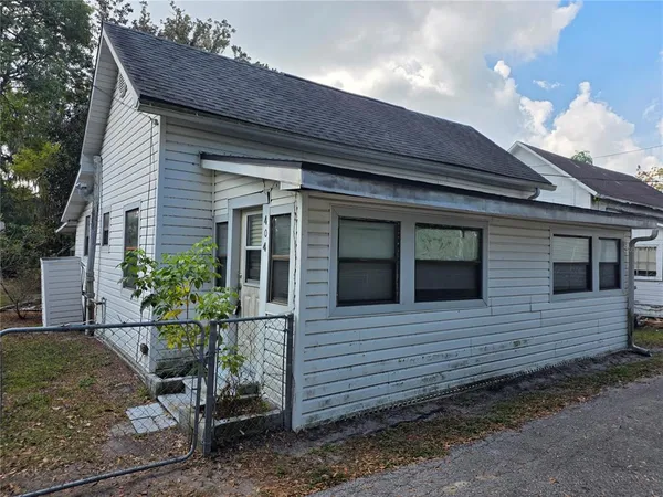a view of a house with a small yard and plants