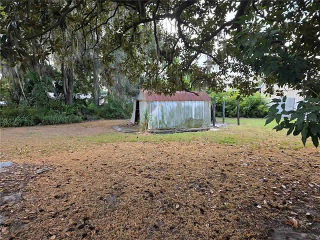 a backyard of a house with a trees