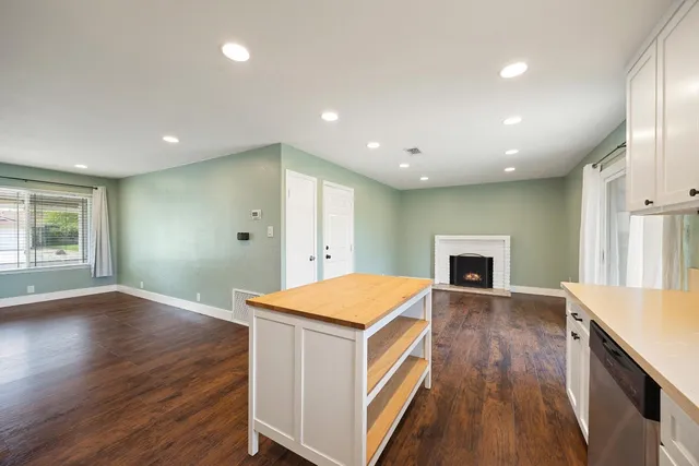 a open kitchen with sink and refrigerator