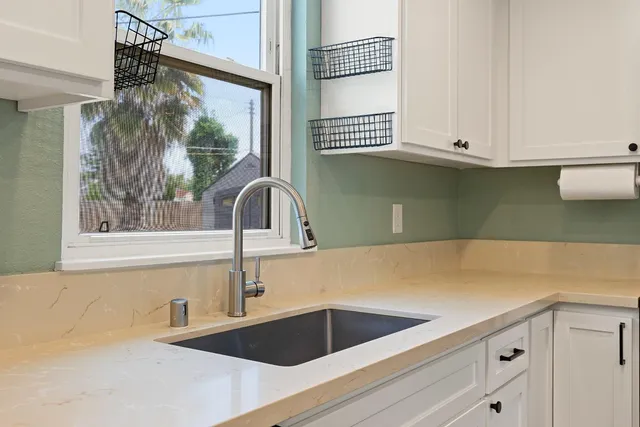 a kitchen with a sink and a window