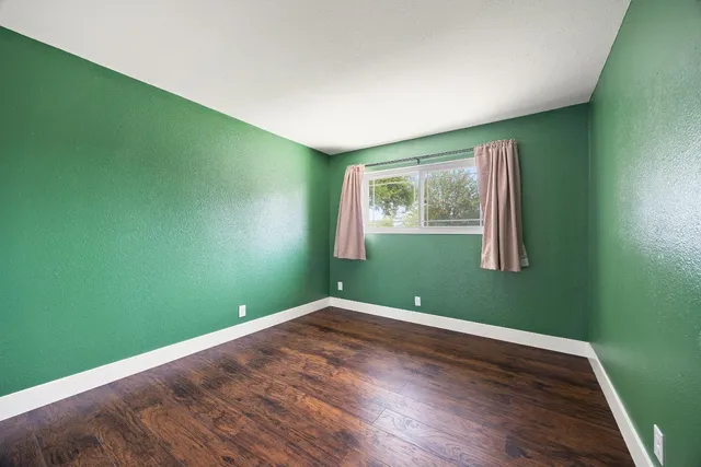 a view of a room with wooden floor and windows