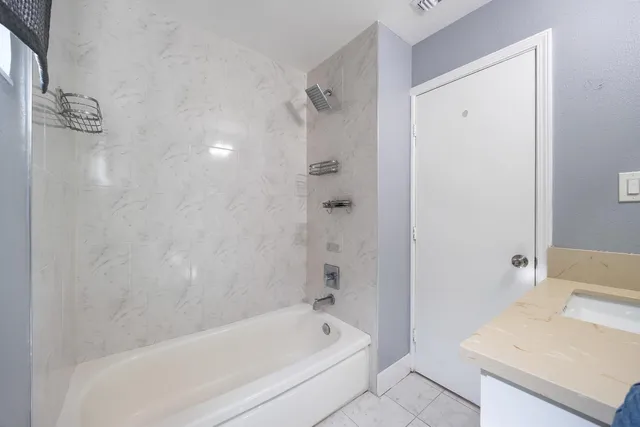 a bathroom with a bathtub and shower