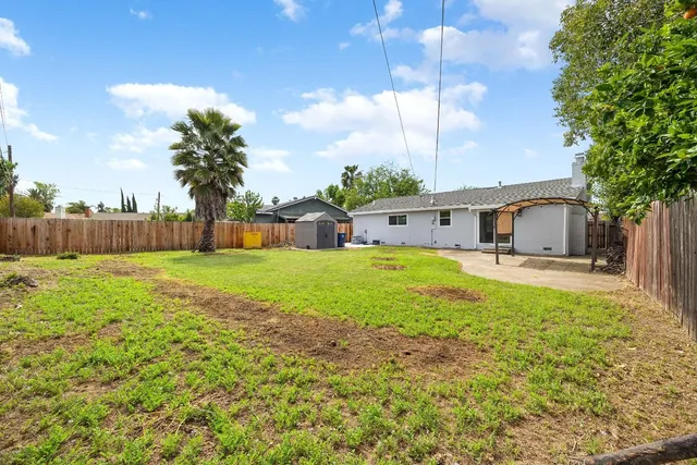 a house view with swimming pool in front of it