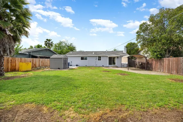 a front view of house with yard and seating area