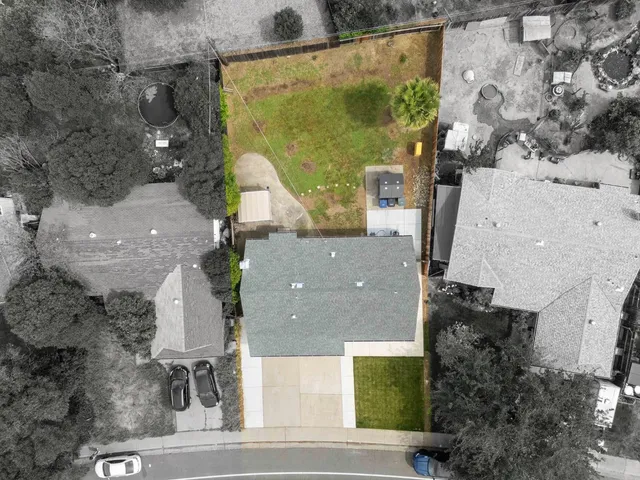 an aerial view of residential houses with outdoor space