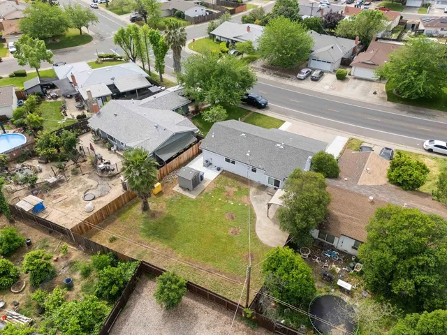 an aerial view of a house with a yard
