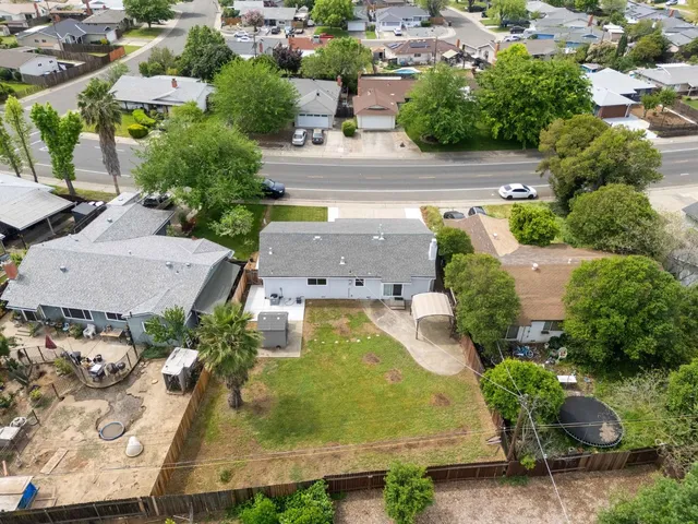 an aerial view of a house with garden space and street view