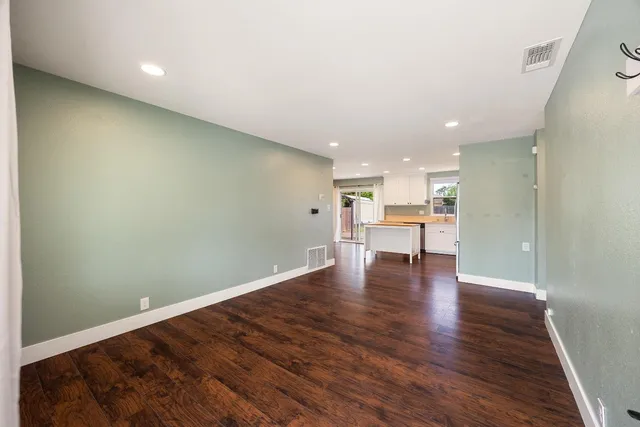 a view of a kitchen with a table and chairs