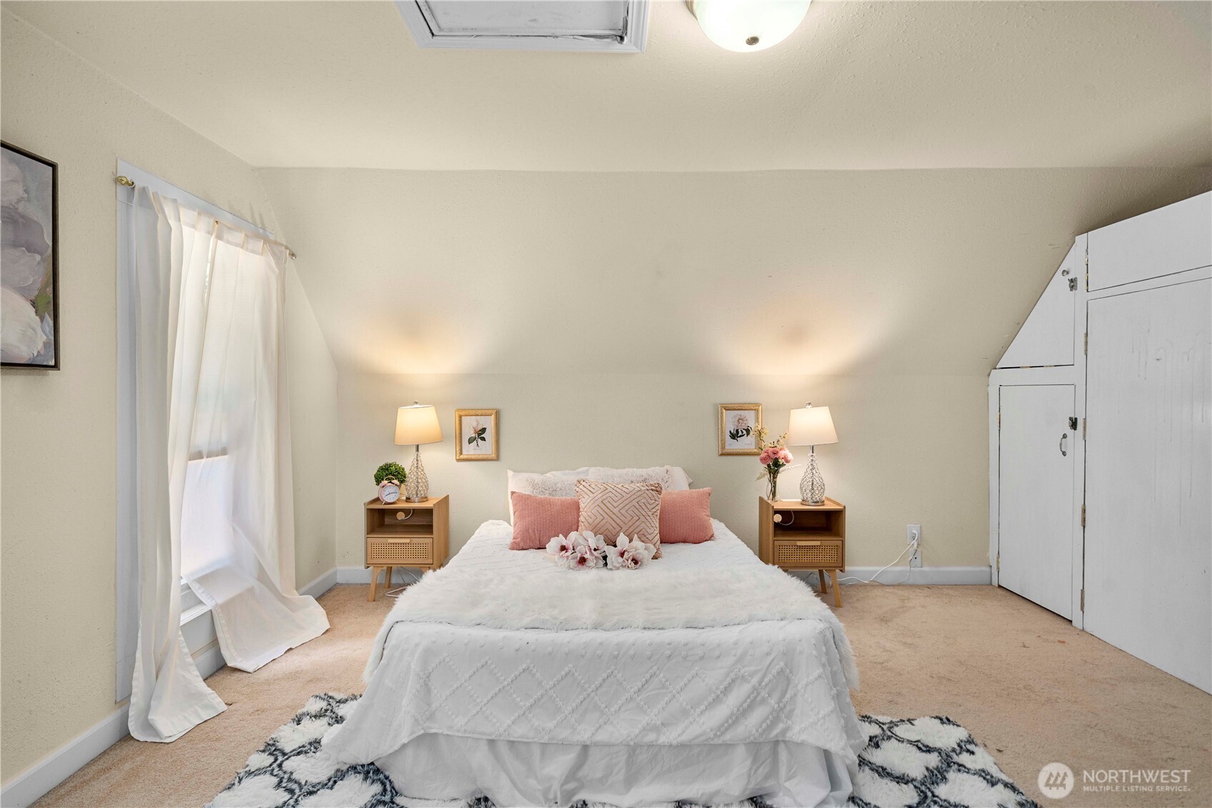 10443 184th Avenue Southwest Rochester, WA 98579 - Photo 23 of 38 a bedroom with a large bed and a chandelier