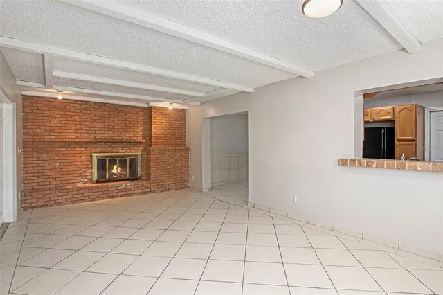 a view of an empty room and fire place