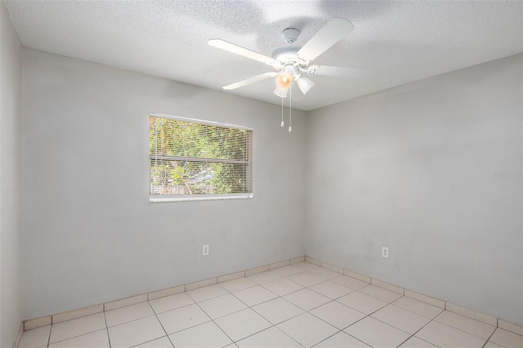 217 Faithway Drive Seffner, FL 33584 - Photo 20 of 29 an empty room with windows and fan