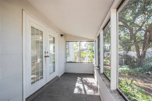 a view of a house with a yard and potted plants