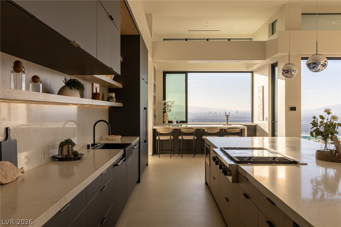 563 Grand Rim Drive Henderson, NV 89012 - Photo 10 of 70 A sleek, contemporary kitchen boasts ample counter space and dramatic city views.