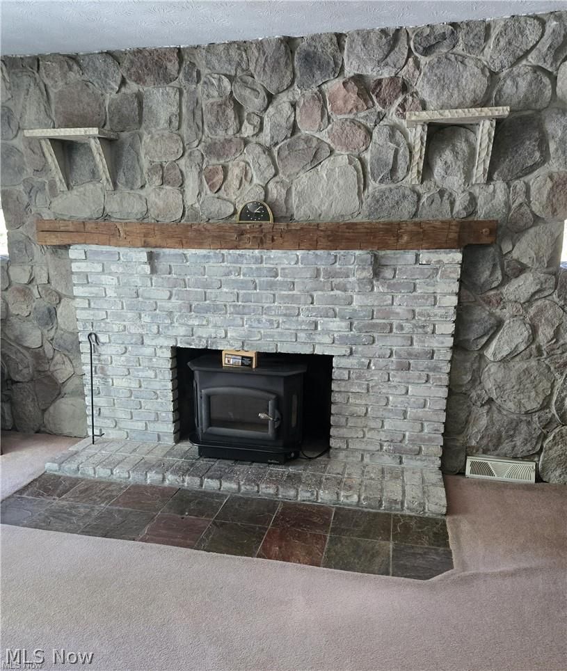 14640 Stone Road Newbury, OH 44065 - Photo 10 of 19 The fireplace insert warms the home