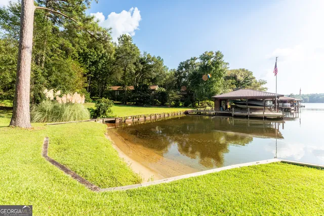 a swimming pool with trees in the background