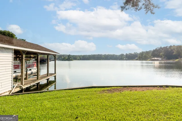 a balcony with wooden floor table and chairs