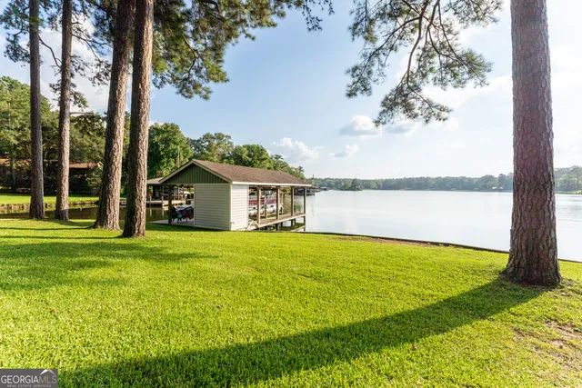 a view of deck with table and chairs barbeque with wooden floor and bench