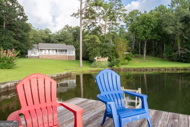 an aerial view of a residential houses with yard