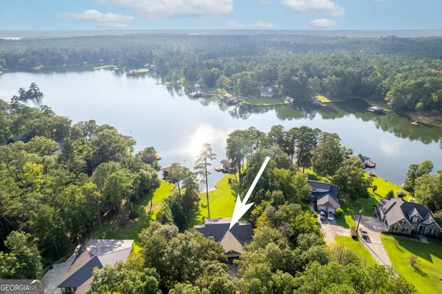 an aerial view of a house with pool yard and outdoor seating