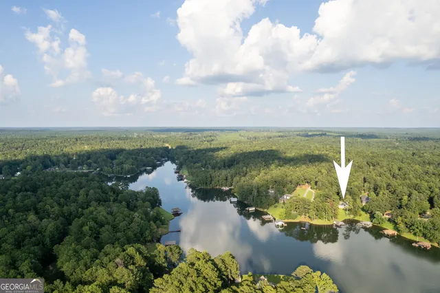 a view of a lake with couches under an umbrella