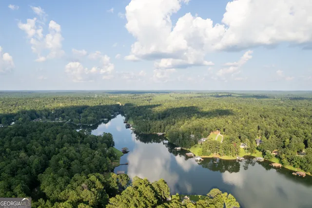 a view of a house with pool and a yard