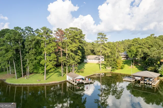 a swimming pool with trees in the background